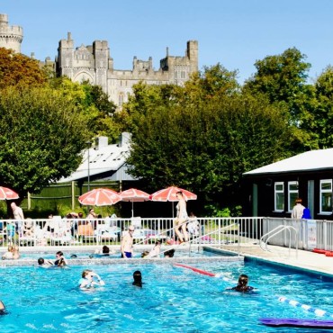A sunny day at Arundel Lido with families enjoying the outdoor pool.