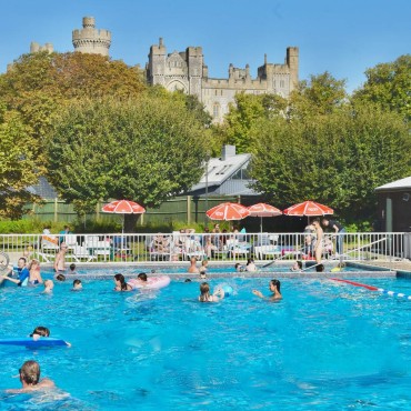 A sunny day at Arundel Lido with families enjoying the outdoor pool.